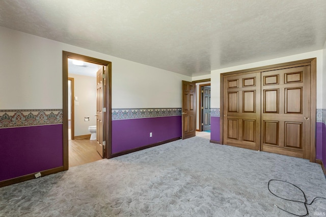 120 Cord Pl, Auburn, IN 46706 - unfurnished bedroom featuring light colored carpet, baseboards, ensuite bath, and a closet