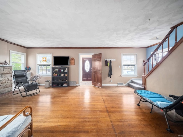 4522 S Calhoun St, Fort Wayne, IN 46807 - foyer entrance featuring wood finished floors, crown molding, stairway, plenty of natural light, and baseboards