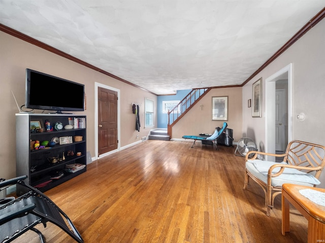 4522 S Calhoun St, Fort Wayne, IN 46807 - living room with wood finished floors, stairs, baseboards, and ornamental molding