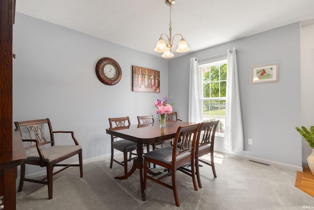 18165 Farmington Hills Dr, South Bend, IN 46637 - dining space with a chandelier, baseboards, and carpet floors