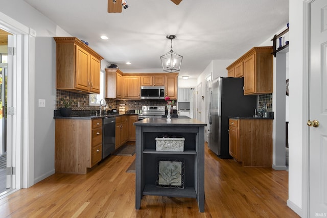 18165 Farmington Hills Dr, South Bend, IN 46637 - kitchen with appliances with stainless steel finishes, open shelves, dark countertops, tasteful backsplash, and light wood-type flooring