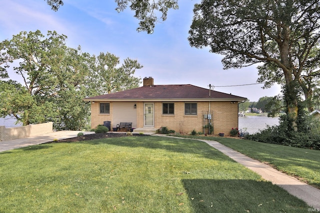 5547 N W Shafer Dr, Monticello, IN 47960 - back of property featuring a chimney, a yard, brick siding, and a patio area