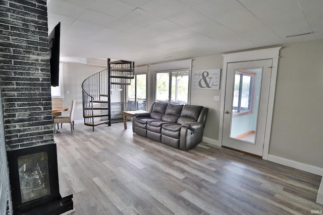 5547 N W Shafer Dr, Monticello, IN 47960 - living room with stairway, plenty of natural light, wood finished floors, and baseboards