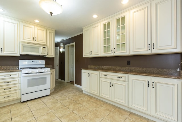 1402 Hampshire Dr, South Bend, IN 46614 - kitchen with white appliances, glass insert cabinets, light tile patterned floors, recessed lighting, and cream cabinetry
