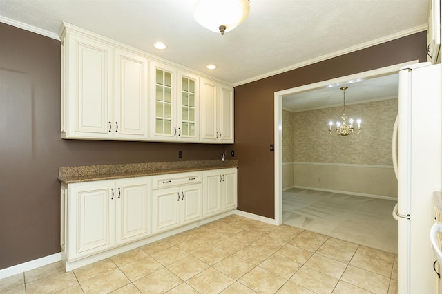 1402 Hampshire Dr, South Bend, IN 46614 - kitchen with freestanding refrigerator, crown molding, glass insert cabinets, light colored carpet, and a chandelier