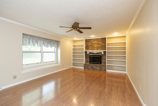 1402 Hampshire Dr, South Bend, IN 46614 - unfurnished living room with ceiling fan, ornamental molding, baseboards, wood finished floors, and a brick fireplace