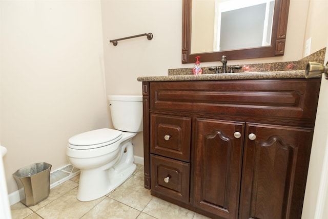 1402 Hampshire Dr, South Bend, IN 46614 - half bathroom with baseboards, tile patterned flooring, vanity, and toilet