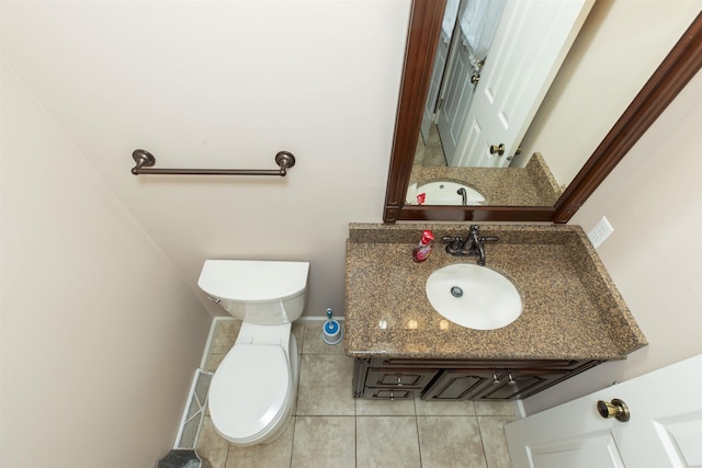 1402 Hampshire Dr, South Bend, IN 46614 - half bath with toilet, tile patterned flooring, vanity, and baseboards