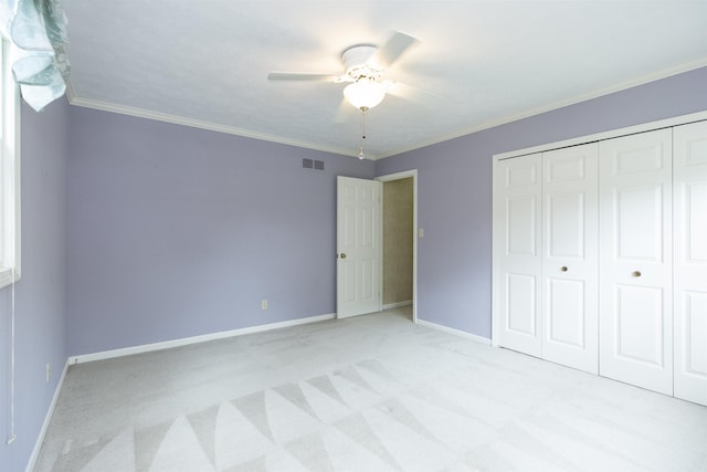 1402 Hampshire Dr, South Bend, IN 46614 - unfurnished bedroom featuring light colored carpet, baseboards, a closet, ornamental molding, and ceiling fan