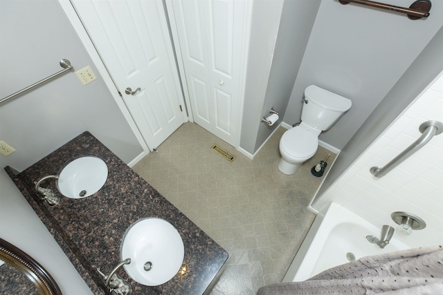 1402 Hampshire Dr, South Bend, IN 46614 - bathroom featuring double vanity, toilet, and tile patterned flooring