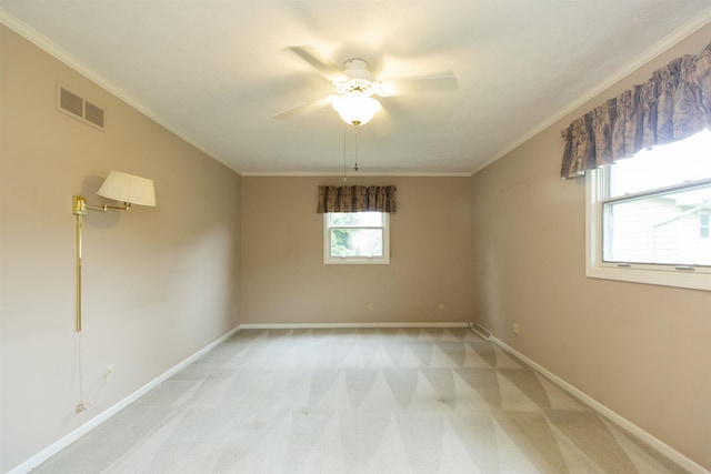 1402 Hampshire Dr, South Bend, IN 46614 - spare room with a ceiling fan, light colored carpet, baseboards, and crown molding