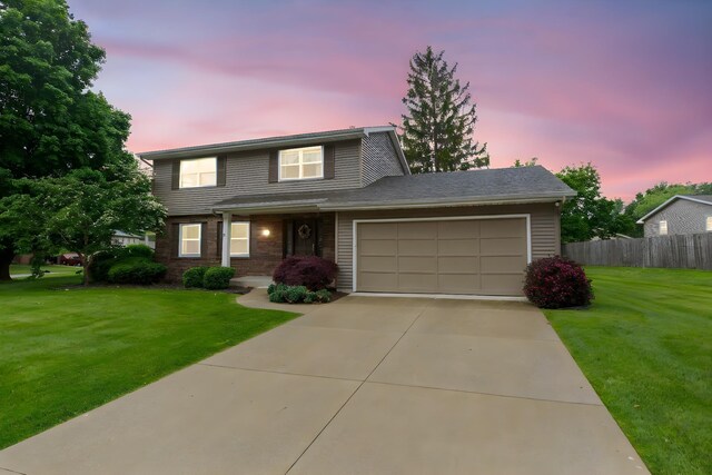 1402 Hampshire Dr, South Bend, IN 46614 - view of front of property with a garage, concrete driveway, and brick siding