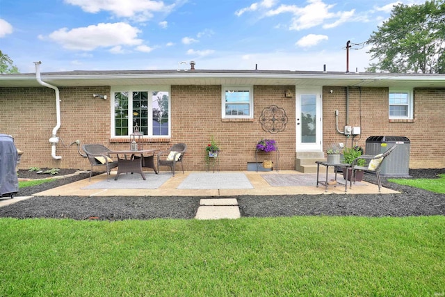1908 N Iroquois Dr, Evansville, IN 47715 - rear view of property featuring central air condition unit, a patio, and a yard