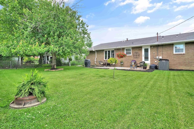 1908 N Iroquois Dr, Evansville, IN 47715 - rear view of house featuring a patio, central AC unit, and brick siding
