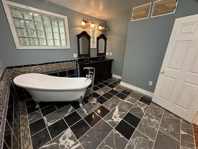 1020 E State St, Albany, IN 47320 - full bath featuring a freestanding tub, double vanity, a wainscoted wall, tile walls, and baseboards