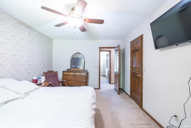 8816 Beacon Woods Pl, Fort Wayne, IN 46804 - bedroom with wallpapered walls, light carpet, an accent wall, a ceiling fan, and baseboards