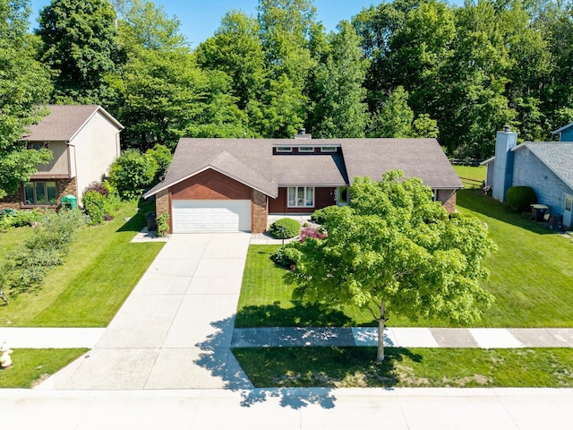 8816 Beacon Woods Pl, Fort Wayne, IN 46804 - mid-century inspired home featuring concrete driveway, a front yard, brick siding, a shingled roof, and an attached garage