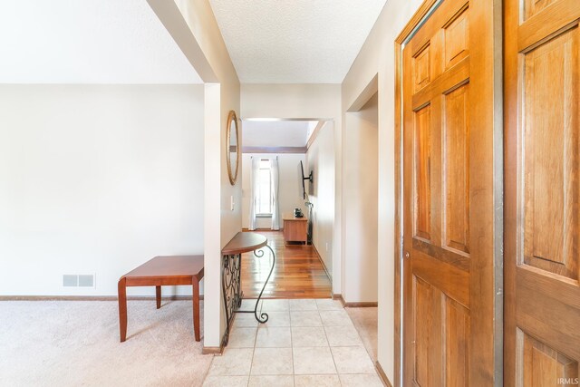 8816 Beacon Woods Pl, Fort Wayne, IN 46804 - hall featuring baseboards, a textured ceiling, and light tile patterned floors
