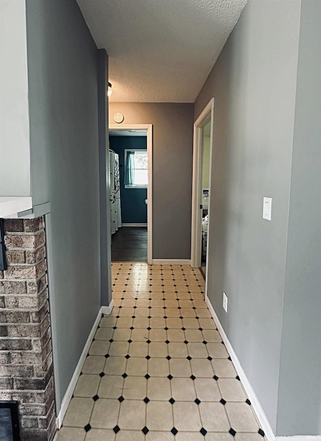 5 E Viola Ave, Washington, IN 47501 - hall featuring tile patterned floors, baseboards, and a textured ceiling