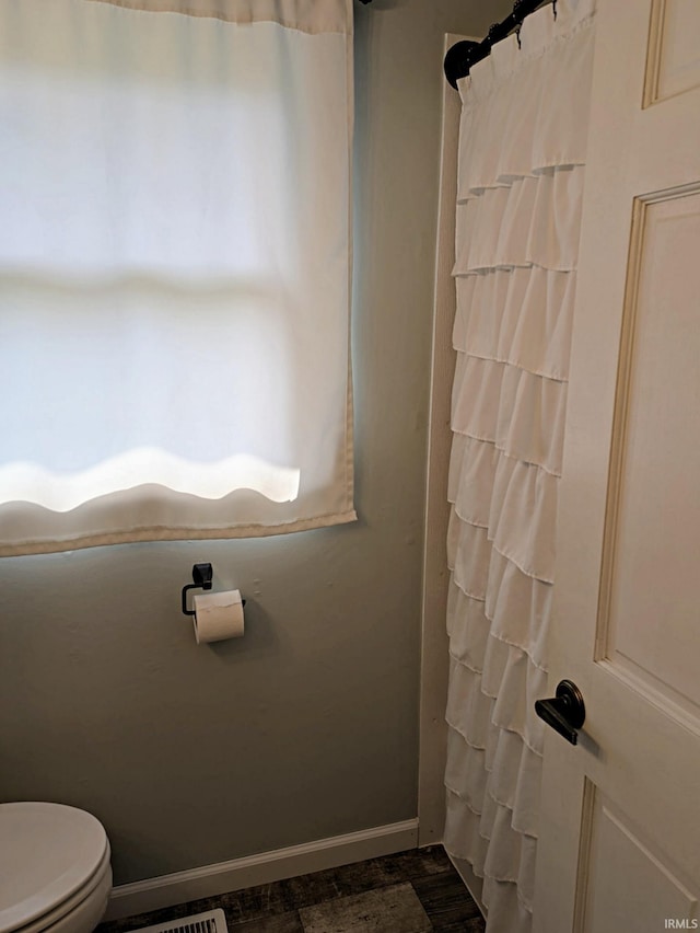 5 E Viola Ave, Washington, IN 47501 - bathroom with toilet, baseboards, and a shower with curtain
