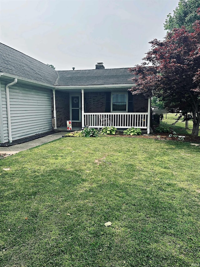 5 E Viola Ave, Washington, IN 47501 - view of front of house featuring covered porch, a front yard, and a chimney