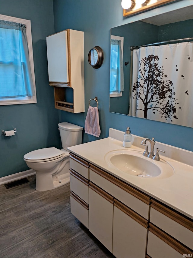 5 E Viola Ave, Washington, IN 47501 - full bath featuring wood finished floors, toilet, vanity, and plenty of natural light