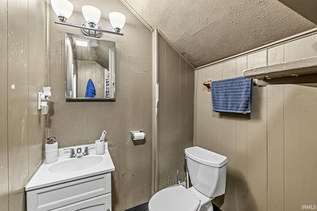 719 W Franklin St, Elkhart, IN 46516 - bathroom with a textured ceiling, vanity, and toilet
