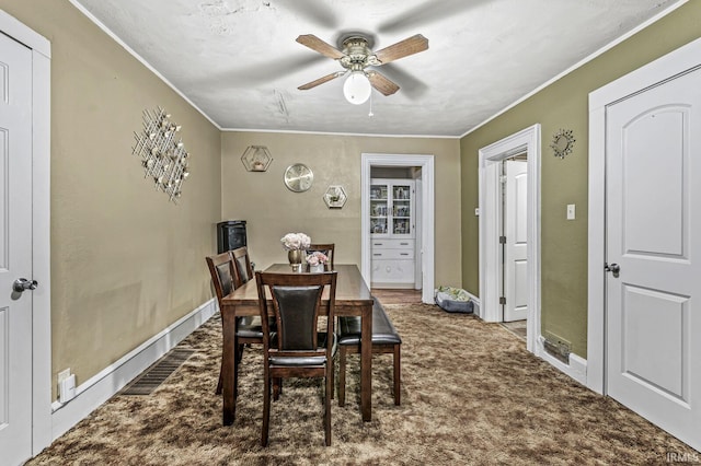 719 W Franklin St, Elkhart, IN 46516 - dining room with a ceiling fan, ornamental molding, carpet flooring, and baseboards