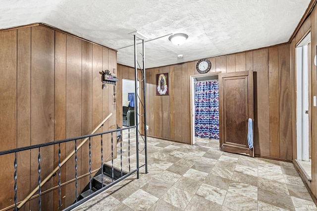 719 W Franklin St, Elkhart, IN 46516 - hall featuring wooden walls and light stone finish flooring
