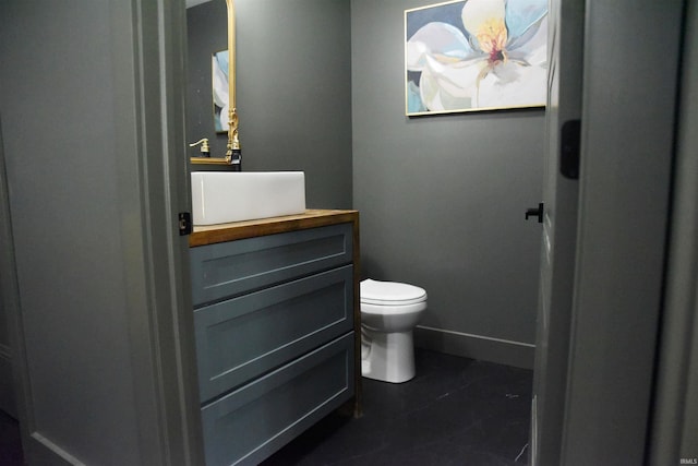 545 Bennett Rd, Bedford, IN 47421 - bathroom with toilet, vanity, baseboards, and tile patterned floors