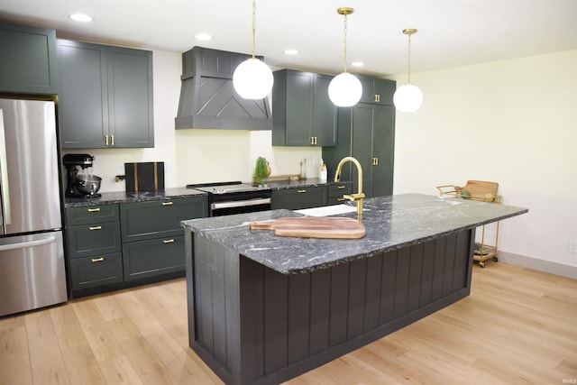 545 Bennett Rd, Bedford, IN 47421 - kitchen with appliances with stainless steel finishes, wall chimney exhaust hood, light wood-style flooring, a sink, and recessed lighting