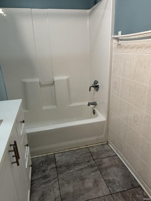 4026 S Lafayette St, Fort Wayne, IN 46806 - full bath featuring vanity, tile walls, bathing tub / shower combination, and marble look tiles