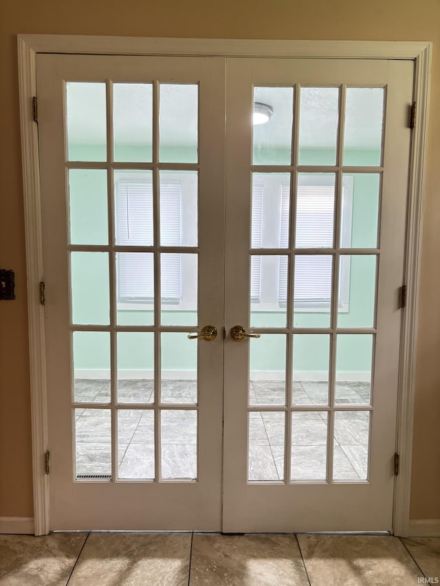 4026 S Lafayette St, Fort Wayne, IN 46806 - doorway with french doors, light tile patterned floors, and baseboards