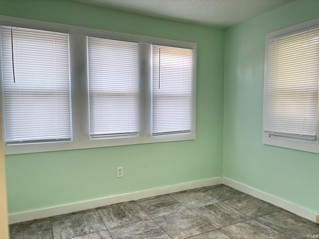 4026 S Lafayette St, Fort Wayne, IN 46806 - empty room with baseboards and a textured ceiling