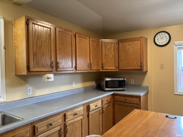 4026 S Lafayette St, Fort Wayne, IN 46806 - kitchen with stainless steel microwave, light countertops, and brown cabinets