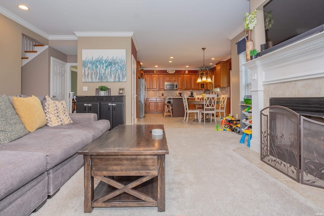 9076 Halston Cir, Newburgh, IN 47630 - living area featuring crown molding, recessed lighting, light colored carpet, a chandelier, and a fireplace