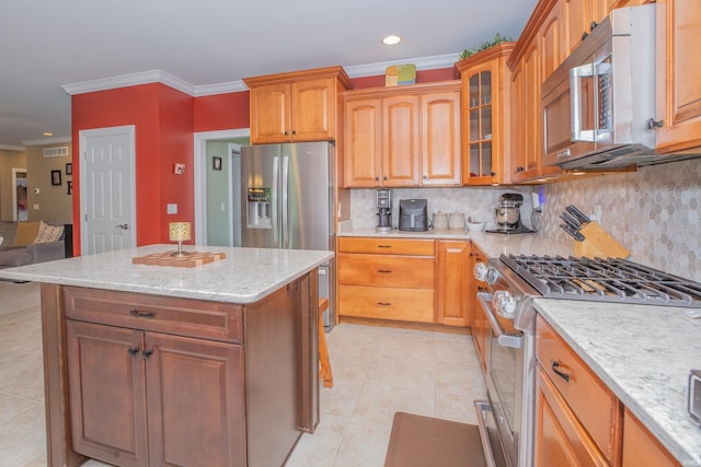 9076 Halston Cir, Newburgh, IN 47630 - kitchen with stainless steel appliances, crown molding, backsplash, light tile patterned floors, and light stone counters