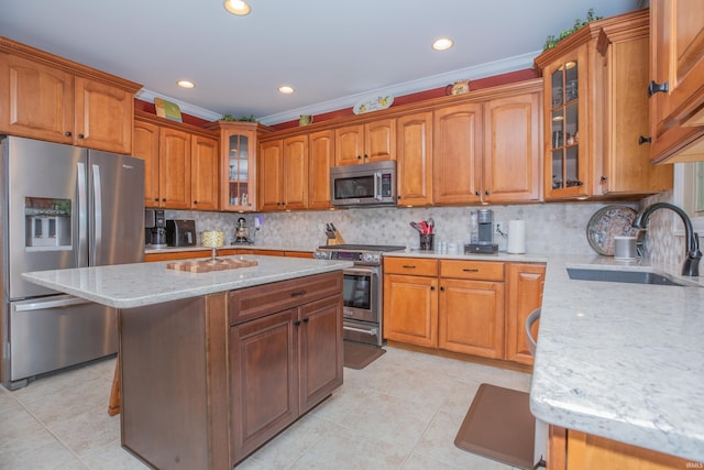 9076 Halston Cir, Newburgh, IN 47630 - kitchen featuring appliances with stainless steel finishes, a sink, light stone countertops, ornamental molding, and decorative backsplash
