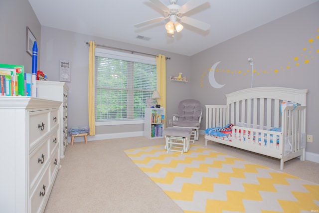 9076 Halston Cir, Newburgh, IN 47630 - bedroom featuring carpet floors, a crib, baseboards, and a ceiling fan