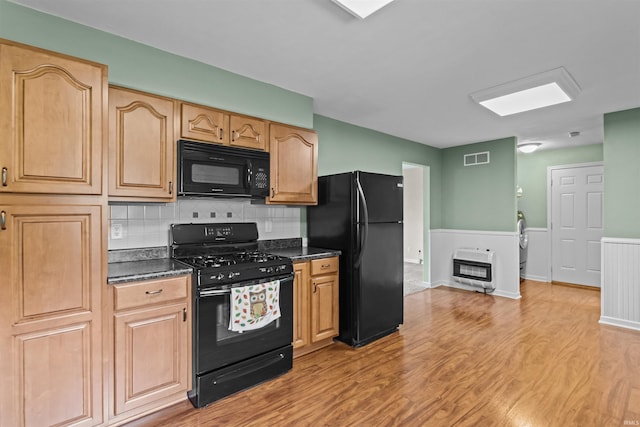 9391 E 100 N, Greentown, IN 46936 - kitchen featuring black appliances, heating unit, light wood-type flooring, tasteful backsplash, and wainscoting