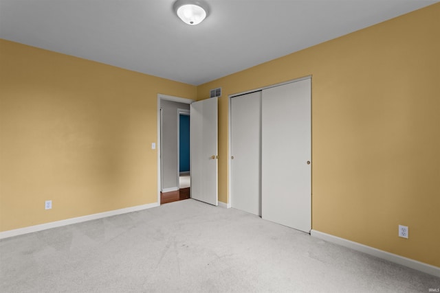9391 E 100 N, Greentown, IN 46936 - unfurnished bedroom with carpet, baseboards, and a closet