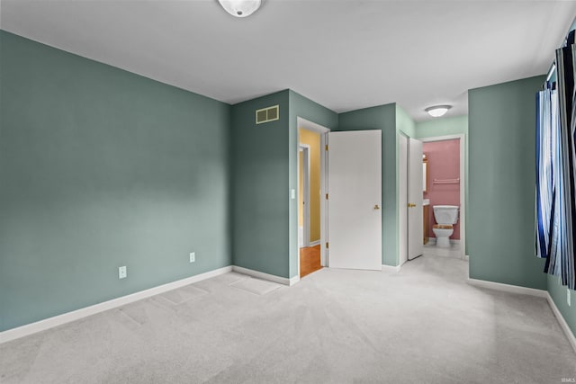 9391 E 100 N, Greentown, IN 46936 - unfurnished bedroom featuring baseboards, carpet flooring, and ensuite bathroom