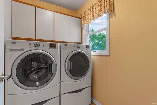 17813 Bromley Chase, South Bend, IN 46614 - laundry room featuring independent washer and dryer, cabinet space, and baseboards
