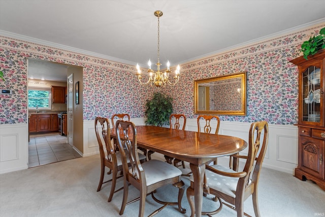 17813 Bromley Chase, South Bend, IN 46614 - dining space with a chandelier, light carpet, wainscoting, ornamental molding, and a decorative wall