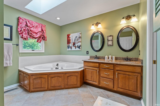 17813 Bromley Chase, South Bend, IN 46614 - full bathroom with a skylight, double vanity, a garden tub, tile patterned flooring, and recessed lighting