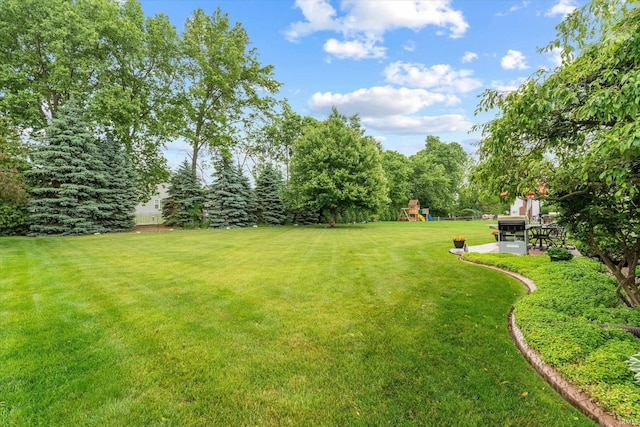 17813 Bromley Chase, South Bend, IN 46614 - view of grassy yard with a playground and a patio