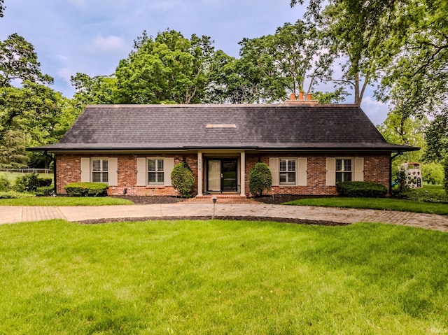 8804 W Tulip Tree Dr, Muncie, IN 47304 - view of front of property featuring a front yard, brick siding, and roof with shingles