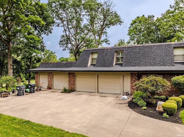 8804 W Tulip Tree Dr, Muncie, IN 47304 - view of front of home with brick siding, roof with shingles, concrete driveway, and an attached garage