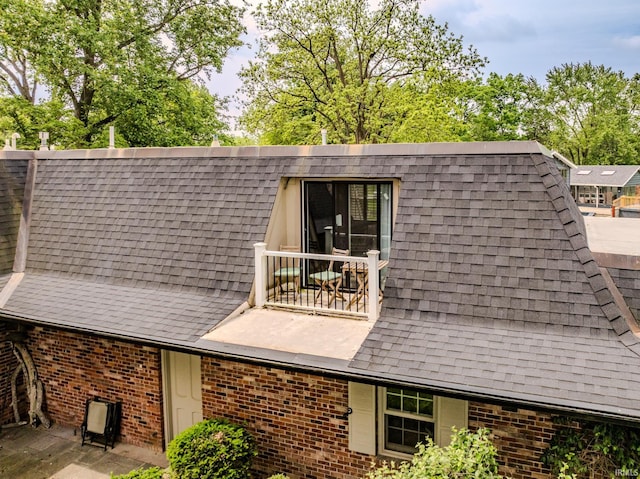 8804 W Tulip Tree Dr, Muncie, IN 47304 - back of house with roof with shingles, brick siding, and a balcony