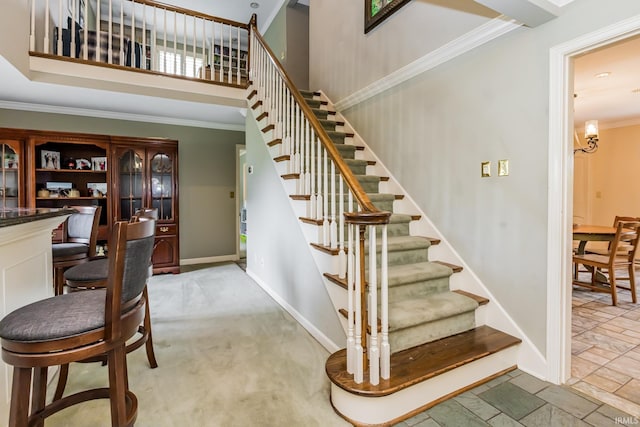 8804 W Tulip Tree Dr, Muncie, IN 47304 - stairs with crown molding, baseboards, stone finish flooring, and a high ceiling
